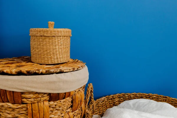 Pile of clothes in laundry basket indoors.