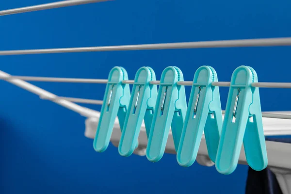 Clothes hanger rack dryer with clothespins close up — Stock Photo, Image