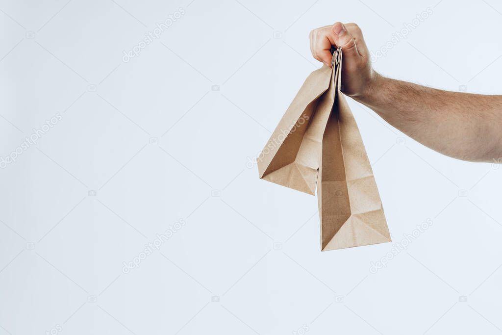 Courier hands giving packed food delivery close up