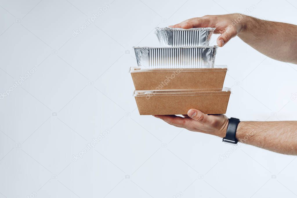 Courier hands giving packed food delivery close up