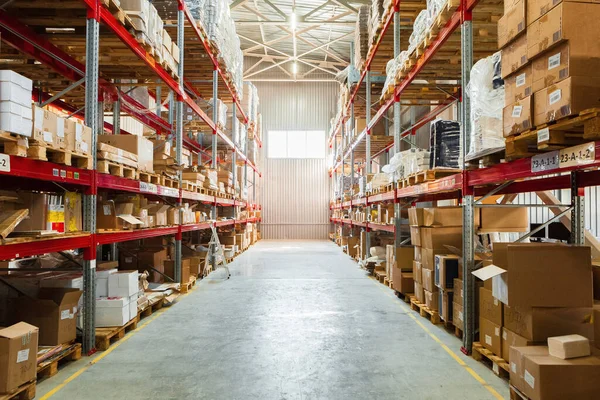 Modern warehouse shelves with pile of cardboard boxes