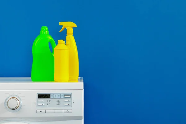 Bottle of detergent whith washing machine, indoors — Stock Photo, Image