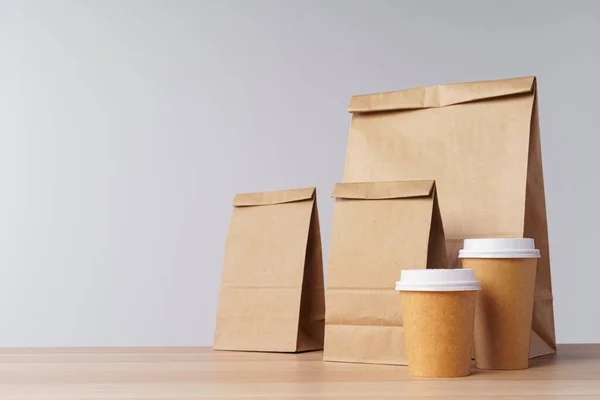 Bolsas de papel con comida para llevar y tazas de café contenedores —  Fotos de Stock