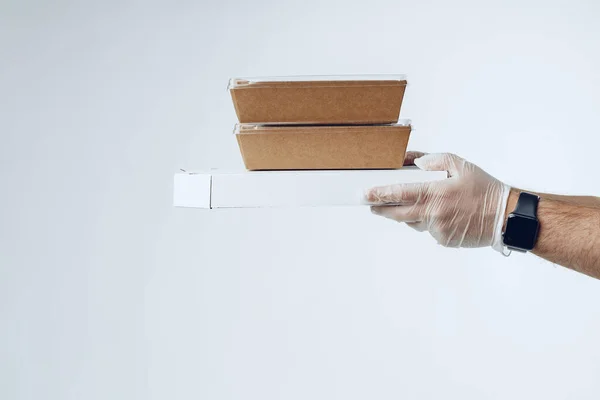 Courier händer i latexhandskar som ger packad mat leverans — Stockfoto