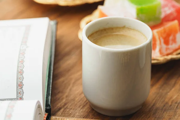 Koffiekopje met oosterse zoetigheden op houten tafel — Stockfoto