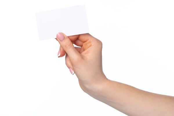 Vacker kvinnlig hand med vitt visitkort på vit bakgrund — Stockfoto