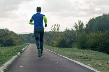 Parkta koşu. Nieumiem koşu giyim spor genç adam