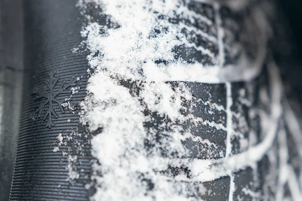 Closeup of car tires in winter. Winter tire with snow