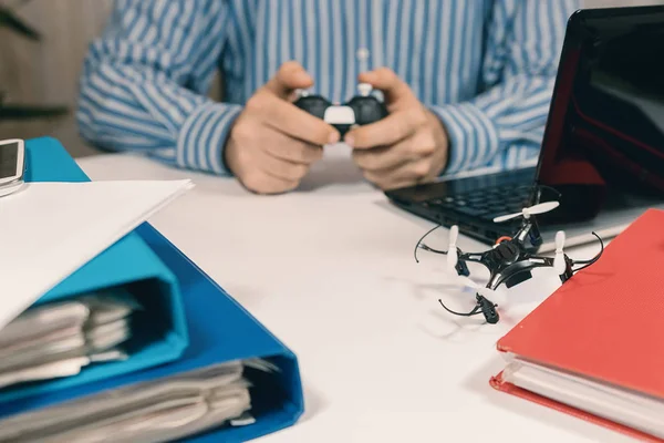 Businessman testing new toy on desk in office. Office playing.