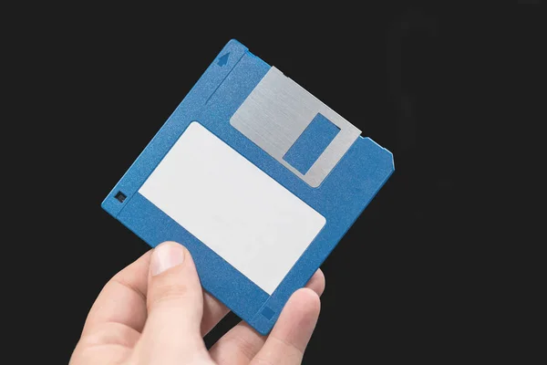 Computer floppy disk in Hand on black background. — Stock Photo, Image