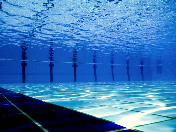 Swimming pool underwater. Underwater background.