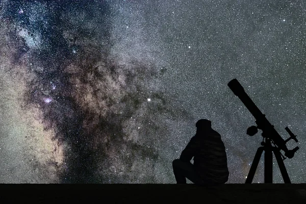 Man looking at the stars, astronomy telescope. Milky Way starry