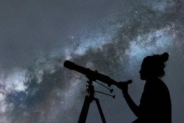 Mulher olhando para as estrelas com telescópio ao lado dela — Fotografia de Stock