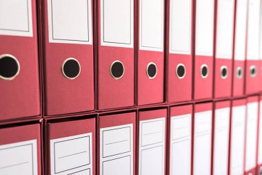 Ciltçi klasörlerde raf, bağlayıcılar üst üste. 