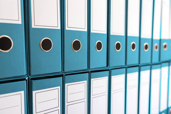 Binder folders in shelf, binders in a row. 