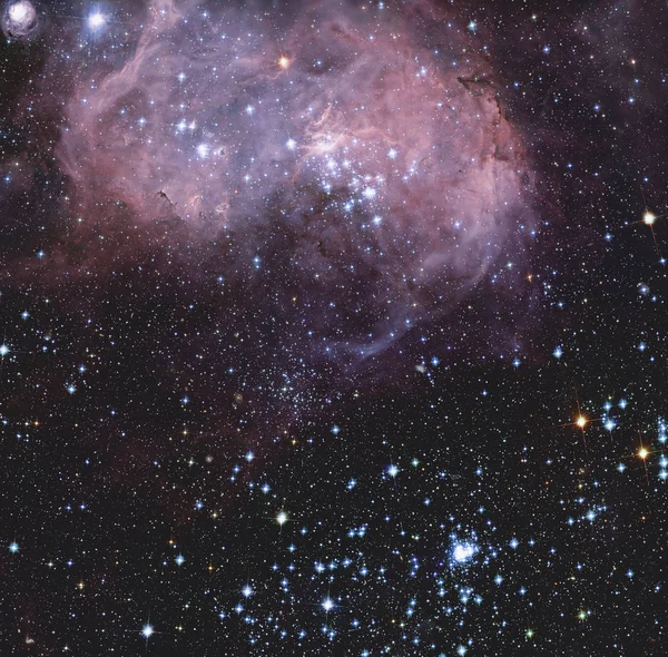 The broad vista of young stars and gas clouds in our neighboring galaxy, the Large Magellanic Cloud.