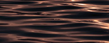 Su yüzeyinde günbatımı