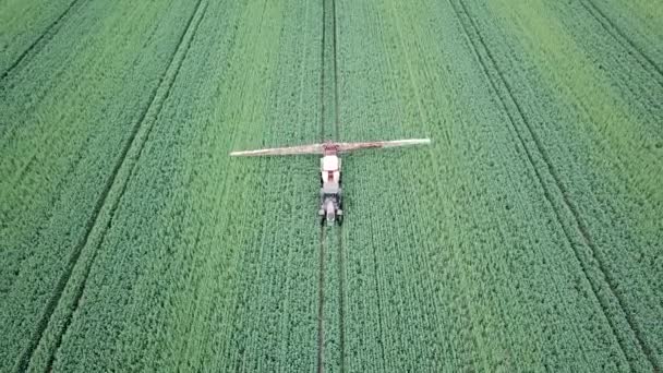 Aerial View Farm Machinery Spraying Chemicals Large Green Field — Stock Video