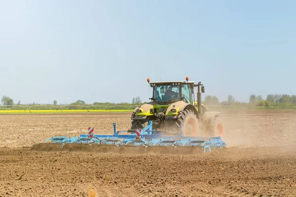 Petani di traktor mempersiapkan penanaman benih tanah. Pertanian — Stok Foto