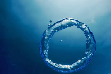 Bubble Ring Underwater ascends towards the Sun. clipart