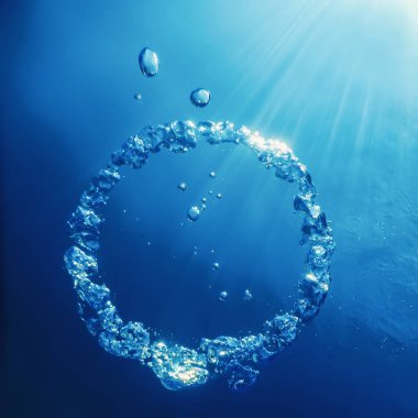 Bubble Ring Underwater ascends towards the Sun. clipart