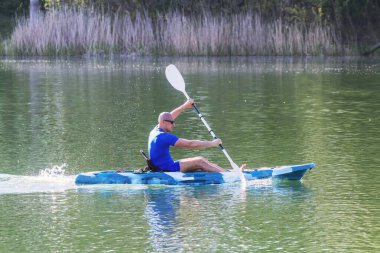 Genç adam gölde kayak yapıyor. Göl Kayağı. 