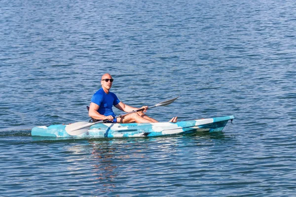 Młody Kayaker Wiosłujący Kajak. Sportowiec kajakarstwo Blue Water. — Zdjęcie stockowe