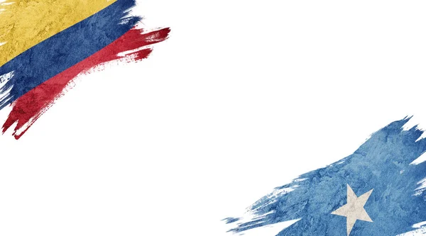 Beyaz arka planda Kolombiya ve Somali bayrakları — Stok fotoğraf