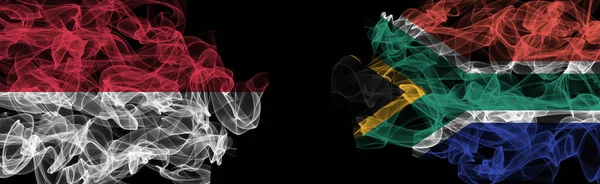 Flags of Indonesia and South Africa on Black background, Indonesia vs South Africa Smoke Flag
