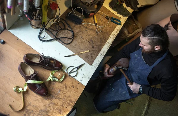 Male shoe maker working