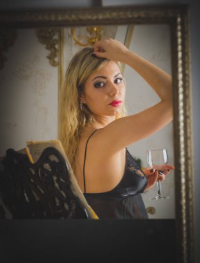 bir bardak şarap, aynaya bir yansıma ile bir giyinme elbisesi içinde tatlı kız.