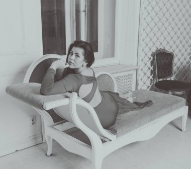  siyah ve beyaz elbiseli güzel kız poz kanepede.