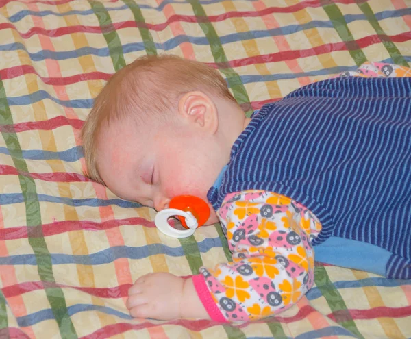 The baby is sleeping on the bed a — Stock Photo, Image