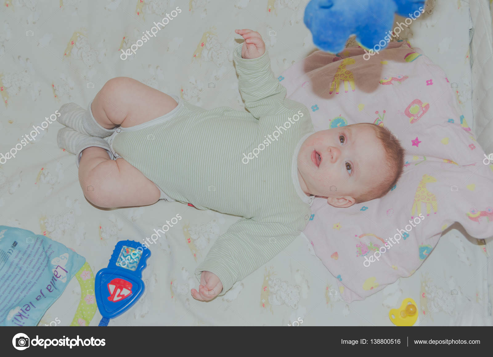 Among the toys in the crib the bab Stock Photo by ©PKDmitry 138800516