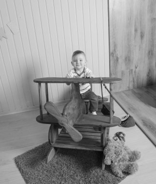  siyah ve beyaz, ahşap bir uçakta, bir çocuk çocuk oynarken