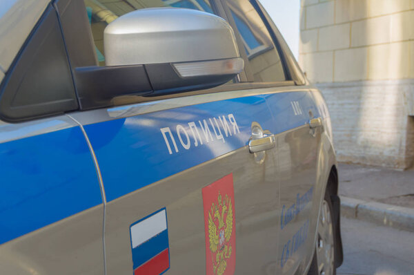 The inscription "Police" on the door of the car.