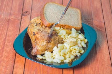 tavuk ve bir çatal ile bir ahşap masa makarna.