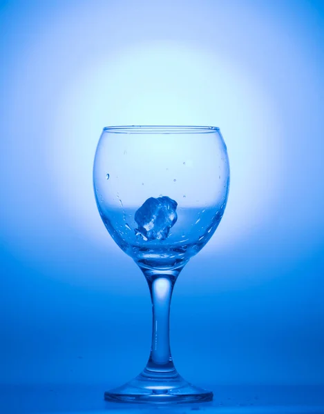 Illuminated blue glass of wine with ice. — Stock Photo, Image