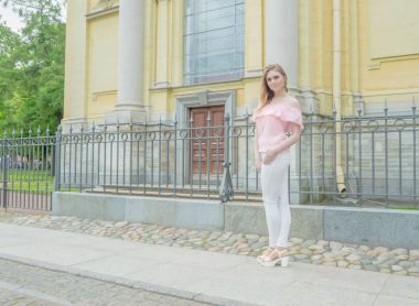 kaldırımda bir pembe bluz çekici bir kız.