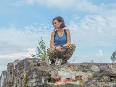 taş duvar tabanca ile kız.