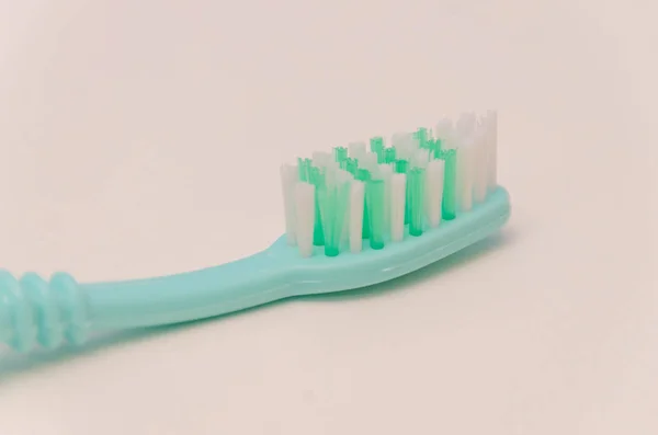 Toothbrush on white table, close-up — Stock Photo, Image