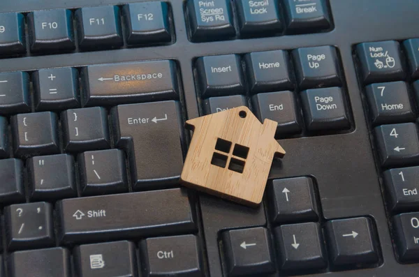 Wooden toy house on the keyboard Royalty Free Stock Photos