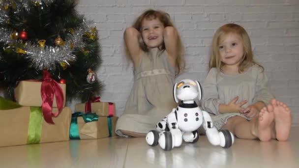 Las vacaciones con regalos robot perro y árbol de Navidad dos hermanas niñas — Vídeos de Stock