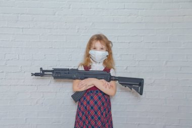 the girl with a gun and a mask on her face during the epidemic clipart