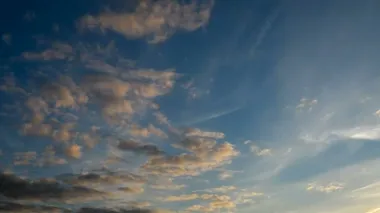 Zaman atlamalı küçük mavi gökyüzü üzerinde kabarık bulutlar. Güzel doğa günbatımı üzerinde. Bulutların arasından uçak uçar.