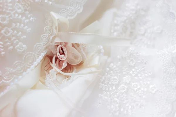 Cute background with laces and silk rose. Details of newborn baby girl's dress. — Stock Photo, Image