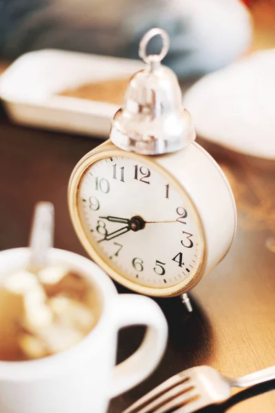 Réveil à l'ancienne et tasse de café. Heure du déjeuner . — Photo