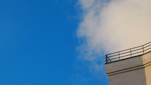 Clip de lapso de tiempo de nubes esponjosas blancas sobre el cielo azul. y esquina del edificio. Hermoso paisaje nublado . — Vídeos de Stock