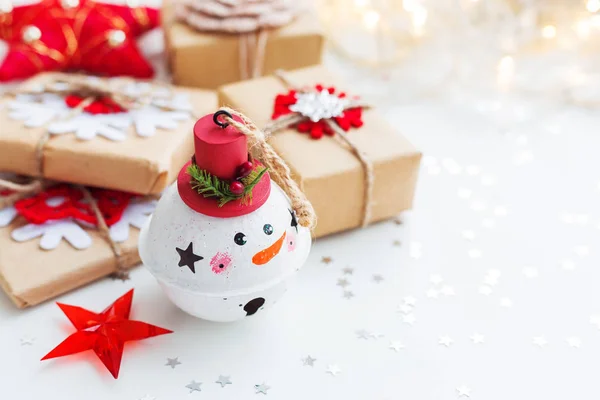 Hóember dekorációs labda, bemutatja és a karácsonyfa díszek karácsonyi és újévi háttér. Holiday háttér csillagok konfetti és a lámpák. Hely a szöveg. — Stock Fotó