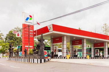 Ubud, Endonezya - 26 Ocak 2013. Benzin istasyonunda çalışan motor gaz ile doldurur. Pertamina benzin istasyonu.